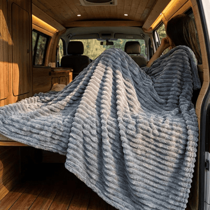 Blue plush throw blanket being used for comfort.
